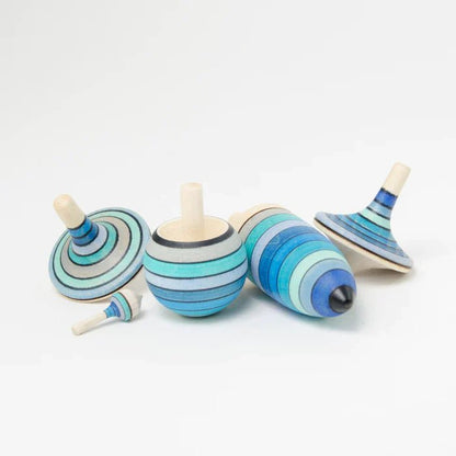 Set of wooden spinning tops with blue striped design on a white background