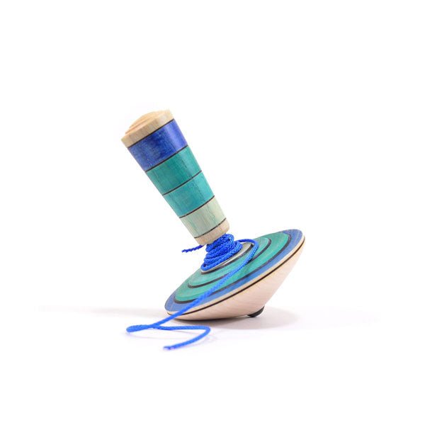 Wooden top with blue string on a white background