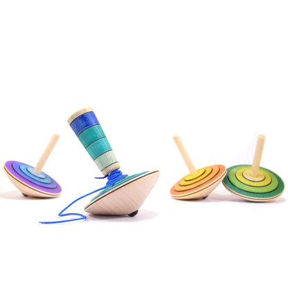 Colorful wooden top toys on a white background