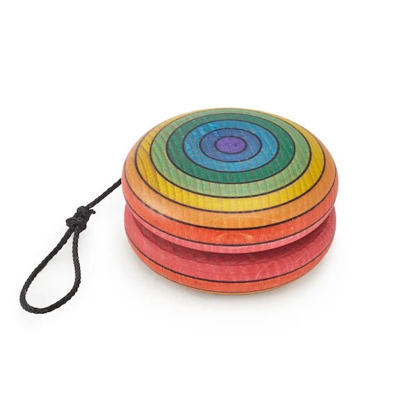 Colorful rainbow striped wooden yoyo with a black string on a white background