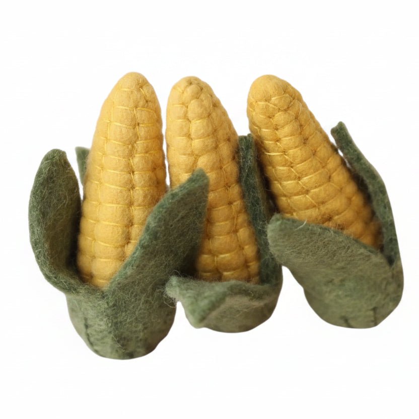 3 ears of felted corn on a white background