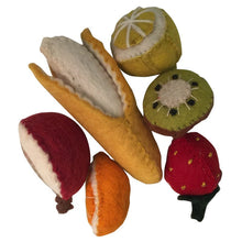 Variety of felt fruits on a white background