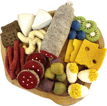 Charcuterie board with felt meats, cheeses, and fruits on a wooden platter