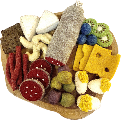 Charcuterie board with felt meats, cheeses, and fruits on a wooden platter