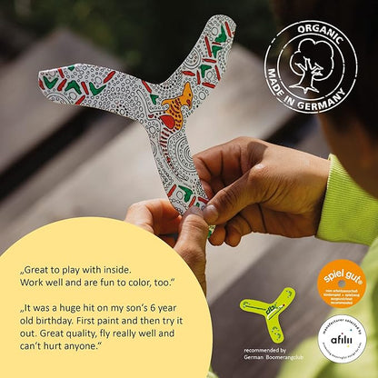 Decorative boomerang held by a person with text and branding elements.