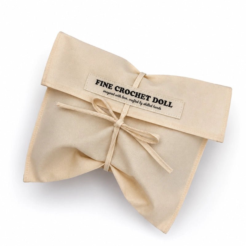 Beige cotton bag that reads "Fine Crochet Doll imagined with love, crafted by skilled hands"