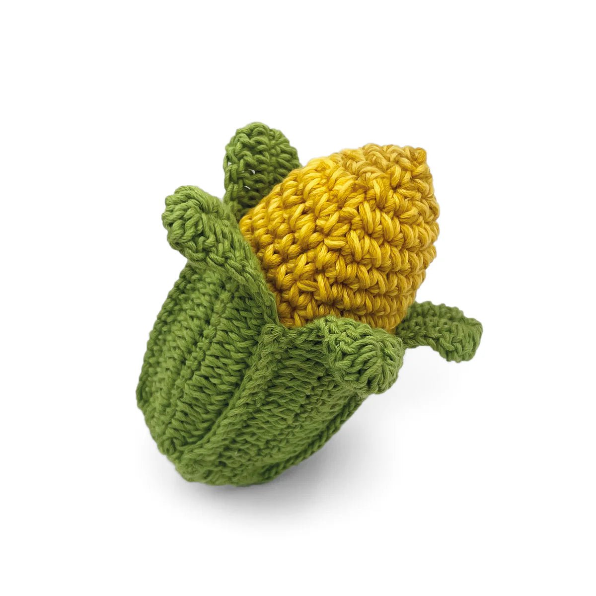 Knitted corn on the cob with green leaves on a white background