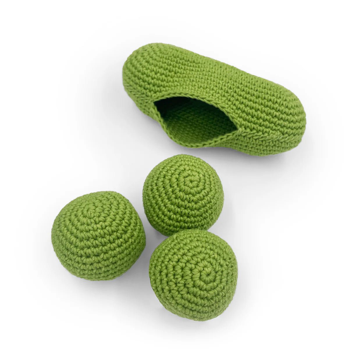 Green crocheted pea pod with three removable peas on a white background