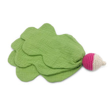 Pink and white radish toy with large green leaves on a white background