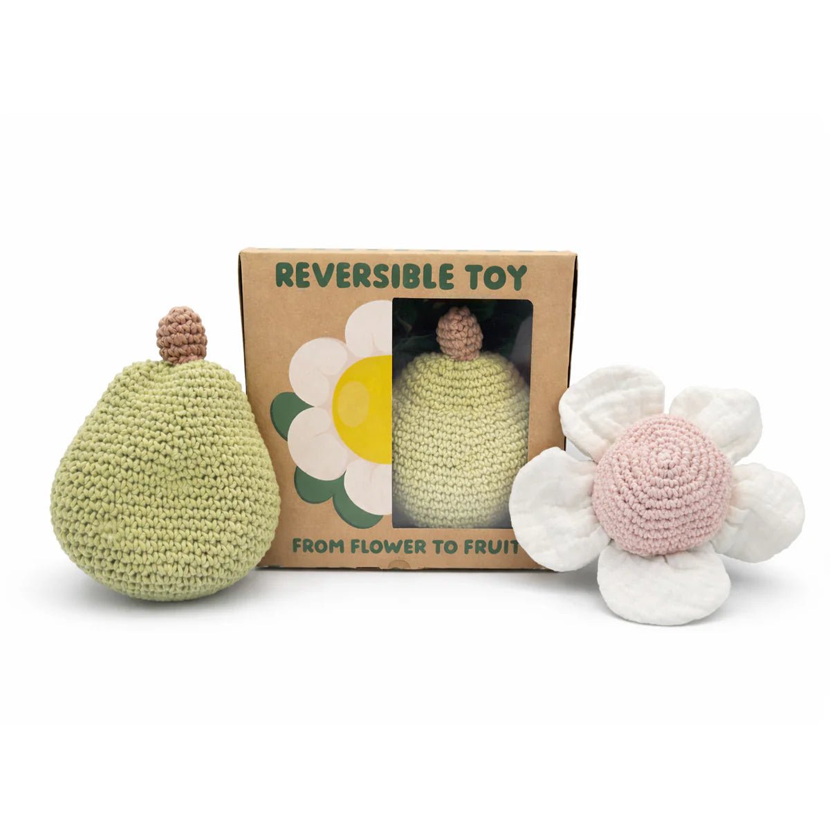 Crocheted toy set with reversible design, including a pear and flower, in front of its packaging on a white background.