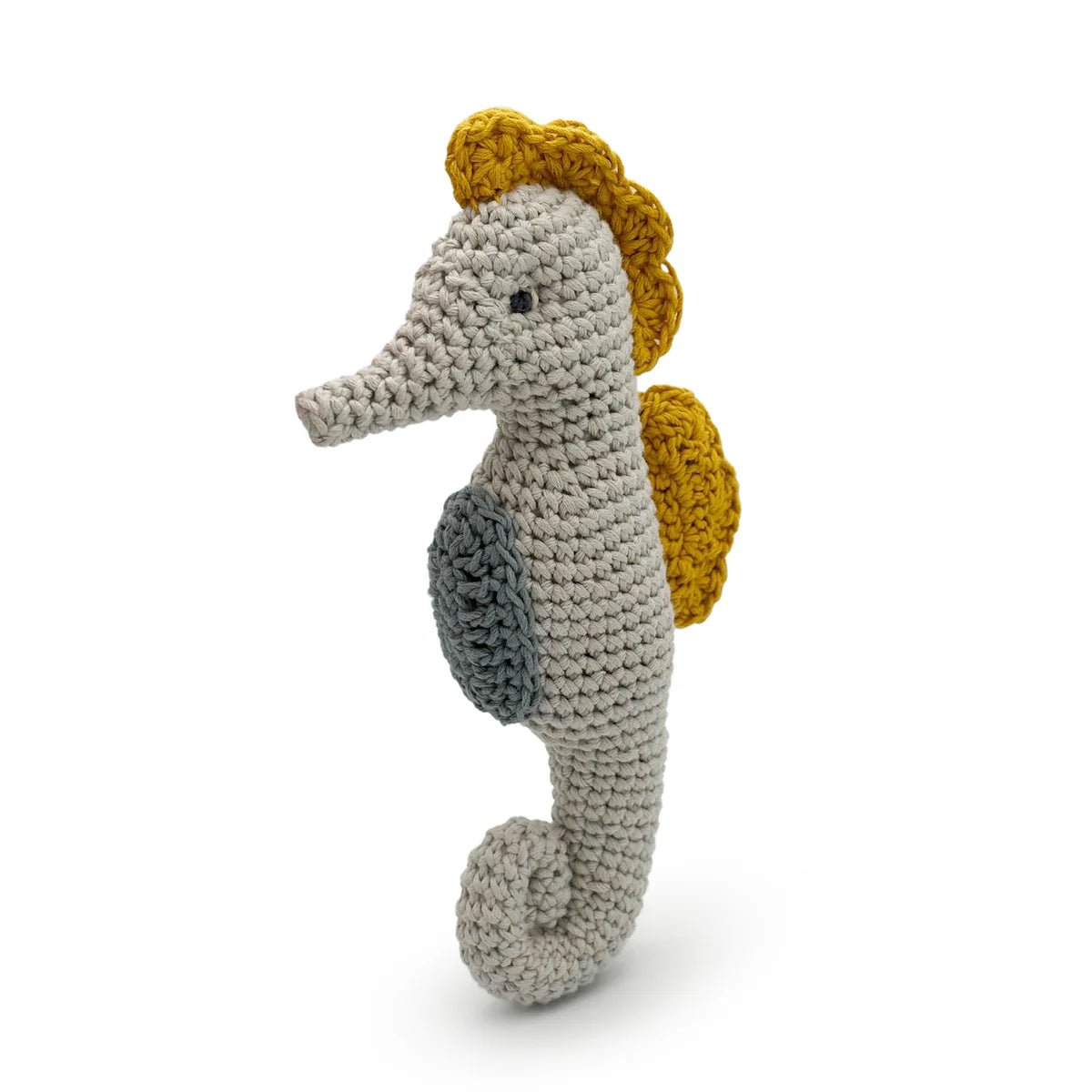 Crocheted seahorse toy with yellow dorsal fin on a white background