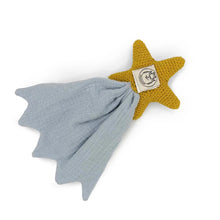 Star-shaped knitted toy with a blue blanket on a white background
