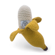 Crocheted banana toy with Myum branding on a white background