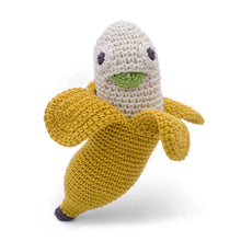 Crocheted banana toy with a face on a white background