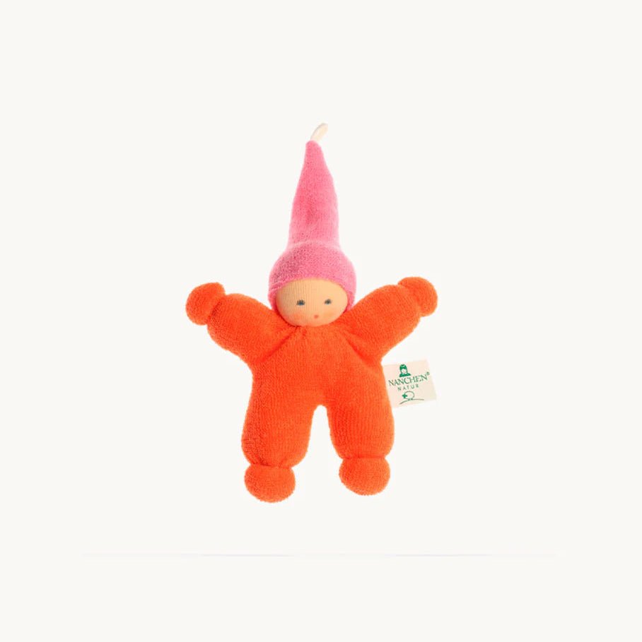 Small orange plush toy with a pink hat on a white background