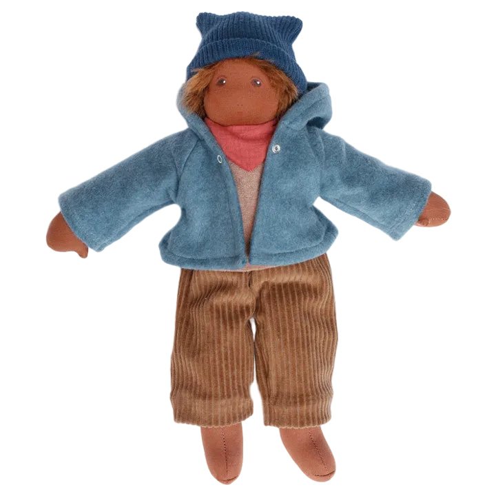 Organic Nanchen doll with dark skin, blue sweater, and brown pants on a white background