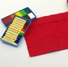 Red crayon holder and crayons on a white background