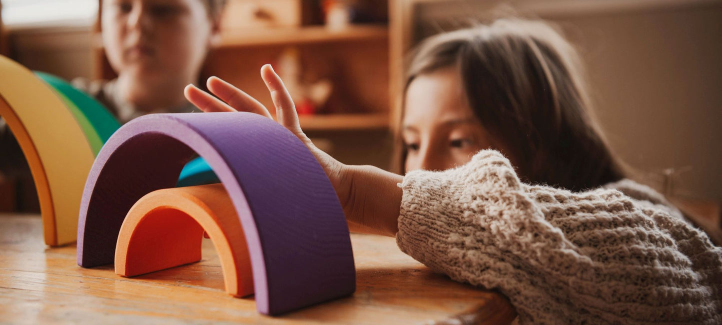 children playing with Ocamora wooden rainbow blocks