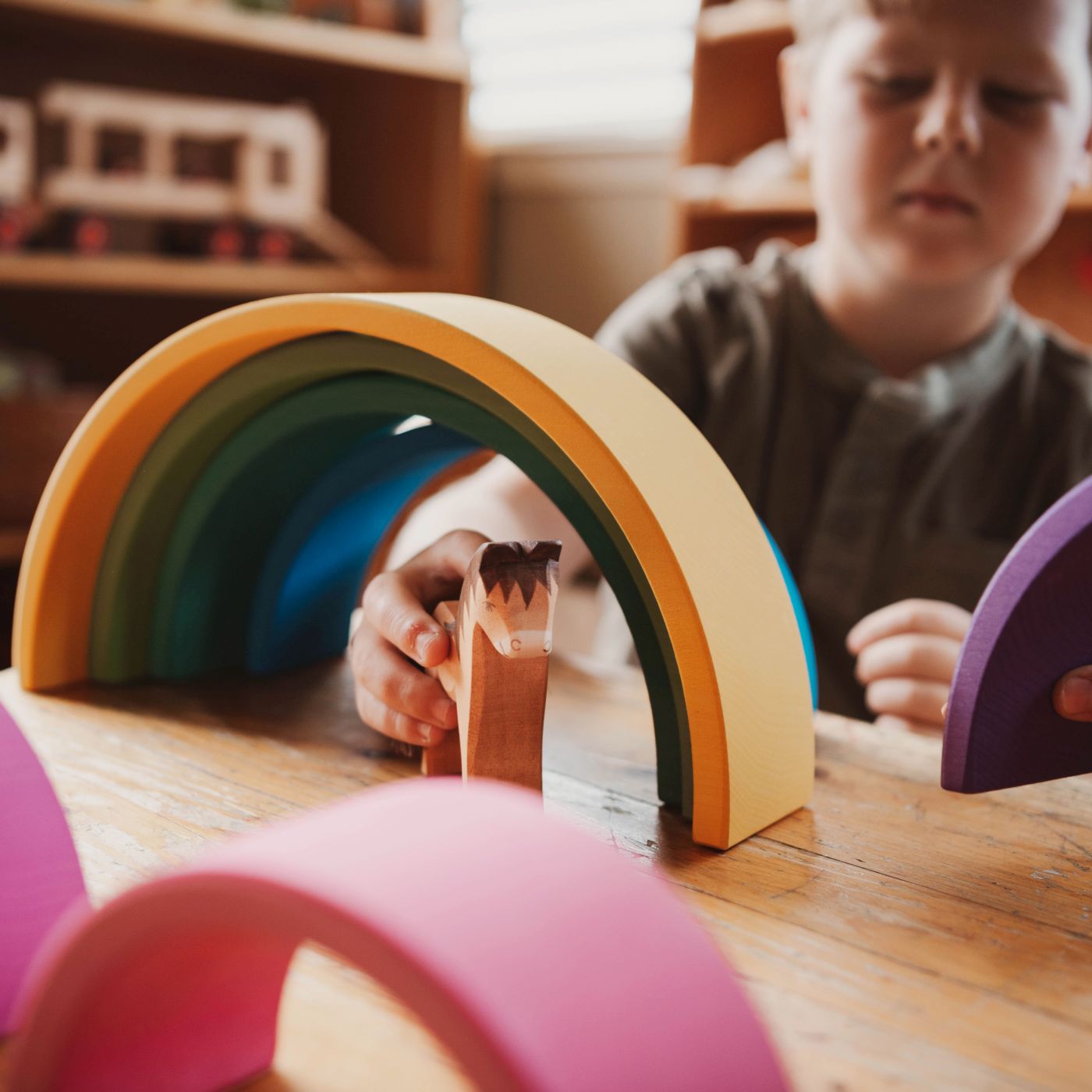 children playing with Ocamora wooden rainbow blocks