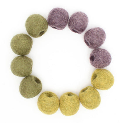 Top down view of felted olives in a circle on a white background