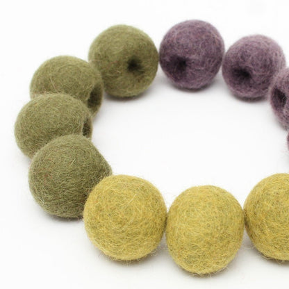 12 felt olives arranged in a circle on a white background