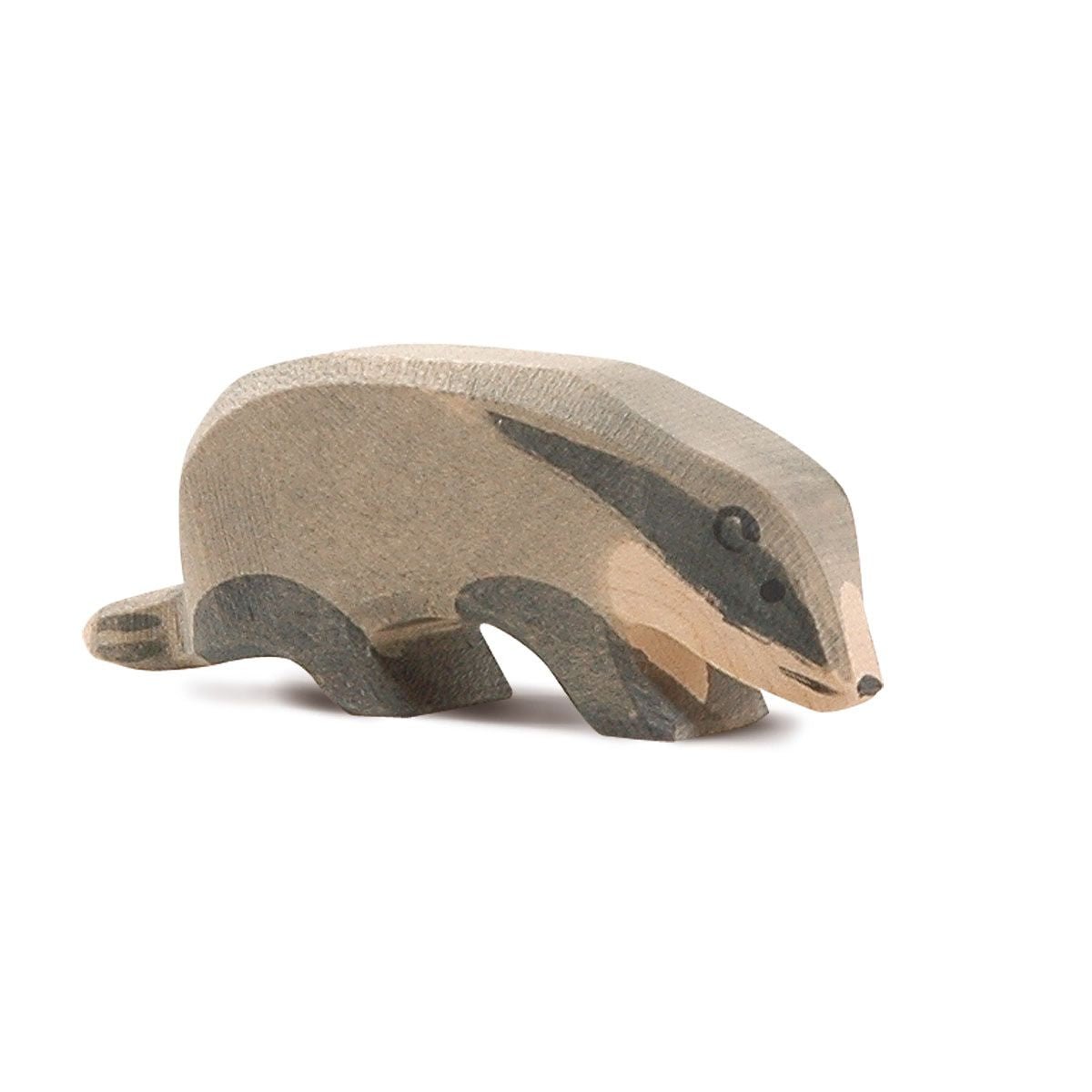 Wooden badger figurine on a white background