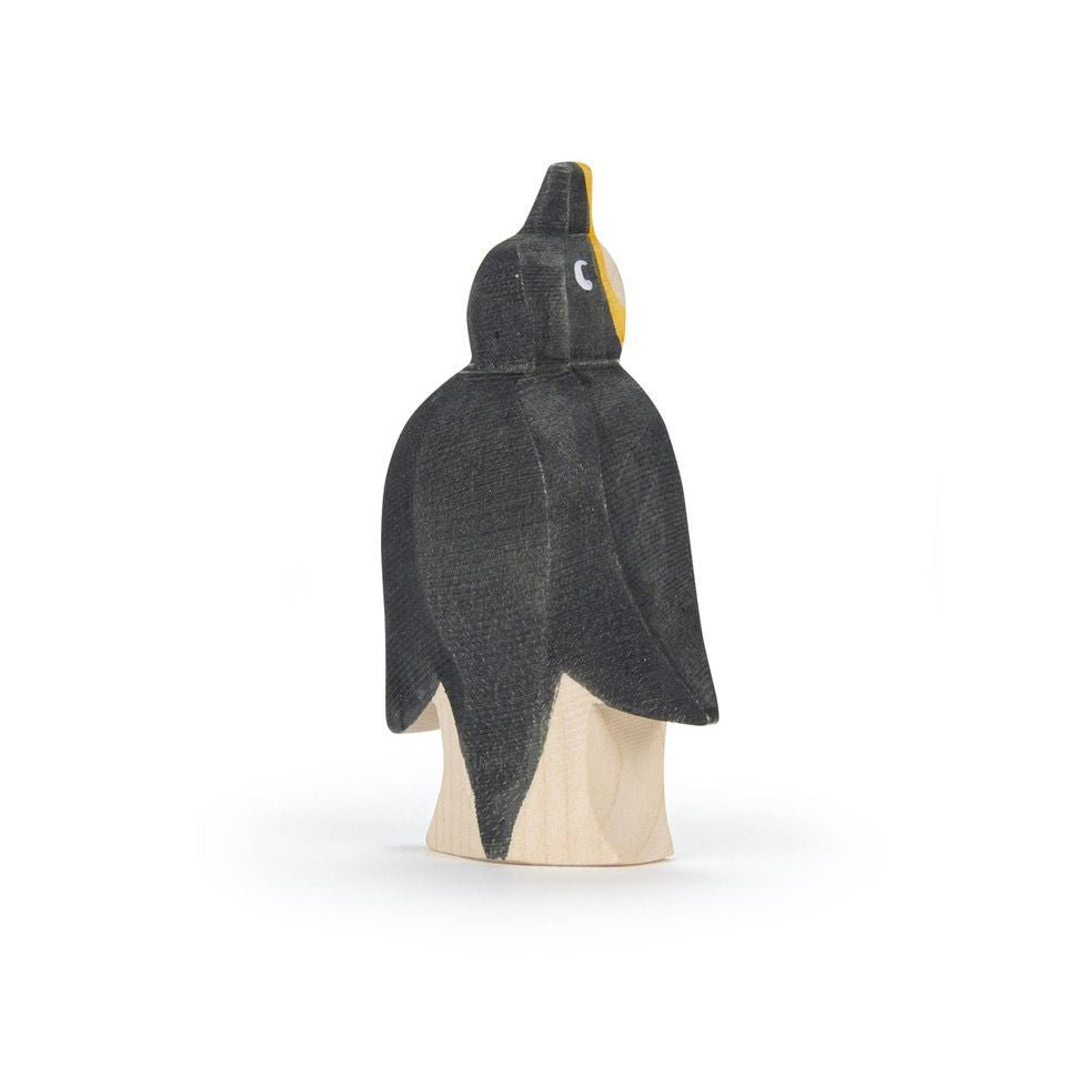 Wooden penguin figurine on a white background