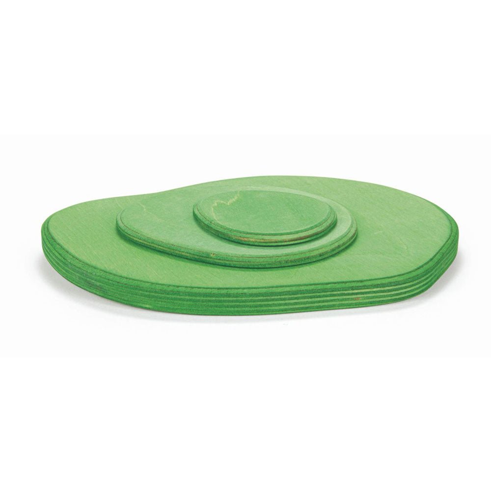 Stack of three green wooden meadow plates in different sizes on a white background