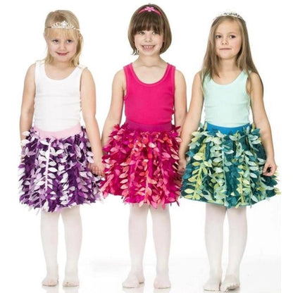 Three young girls wearing colorful petal skirts and tank tops on a white background