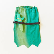 Green silk costume with a green silk dagger in the waistband on a white background