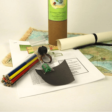 Pirate Map Making Kit with cylindrical container, map, and tools on a white background
