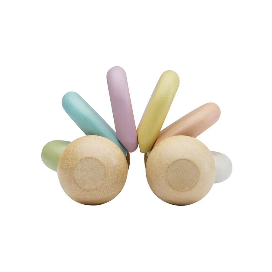 Side view of Plan Toys pastel baby car on a white background