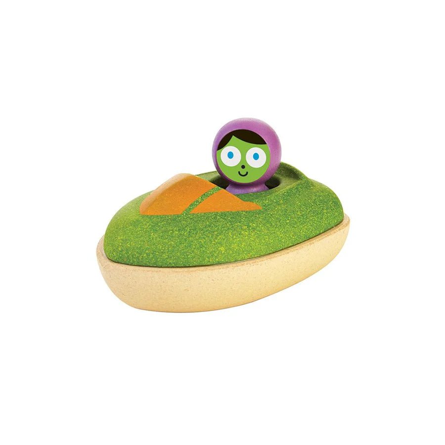 Green wooden toy speedboat with driver on a white background