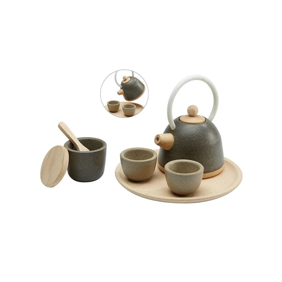 Wooden play tea set on a white background