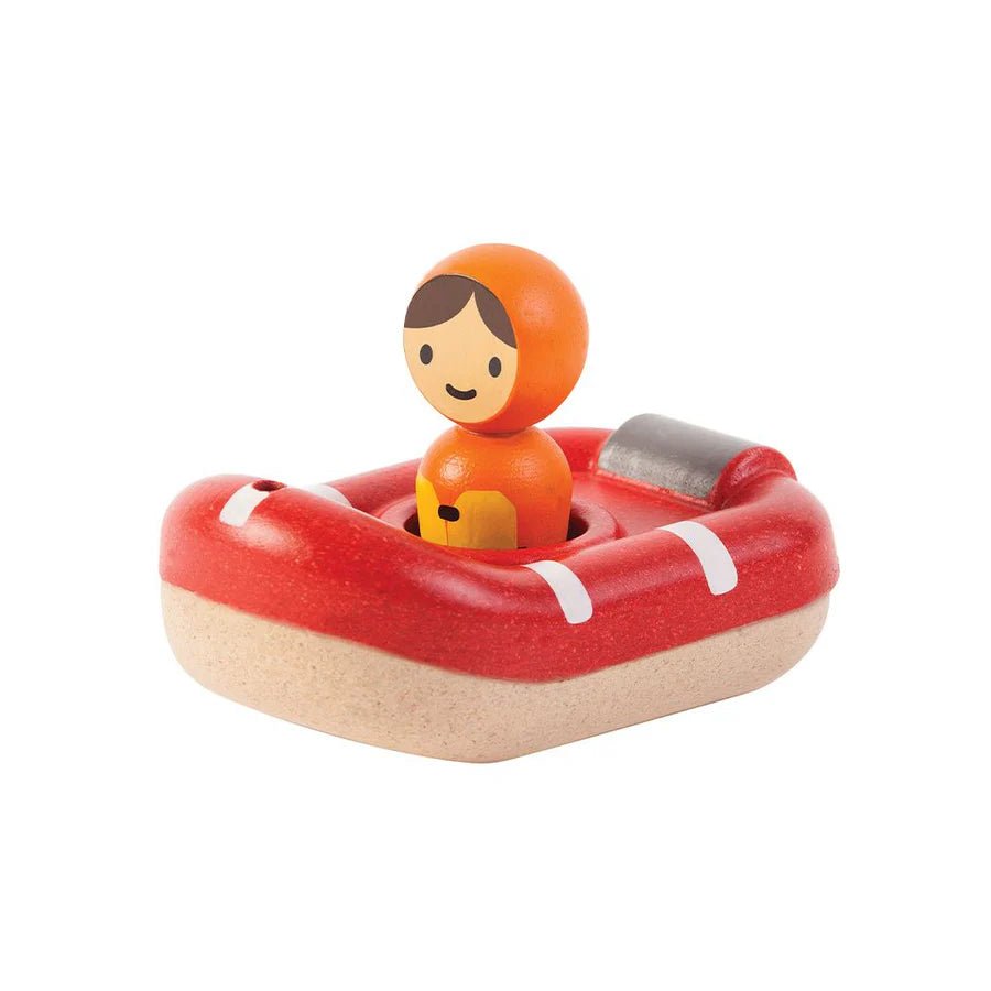 Wooden toy lifeboat with a figure on a white background