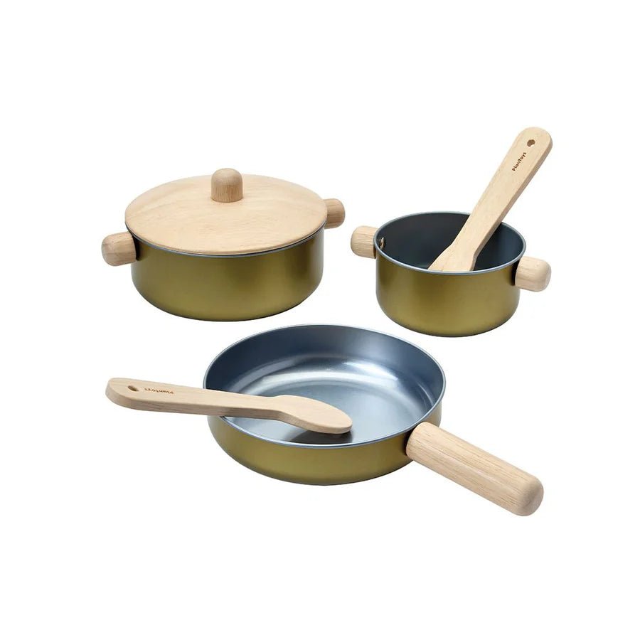 Set of toy cookware with pots and pans on a white background