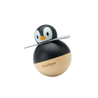 Wooden penguin toy with a rounded base on a white background