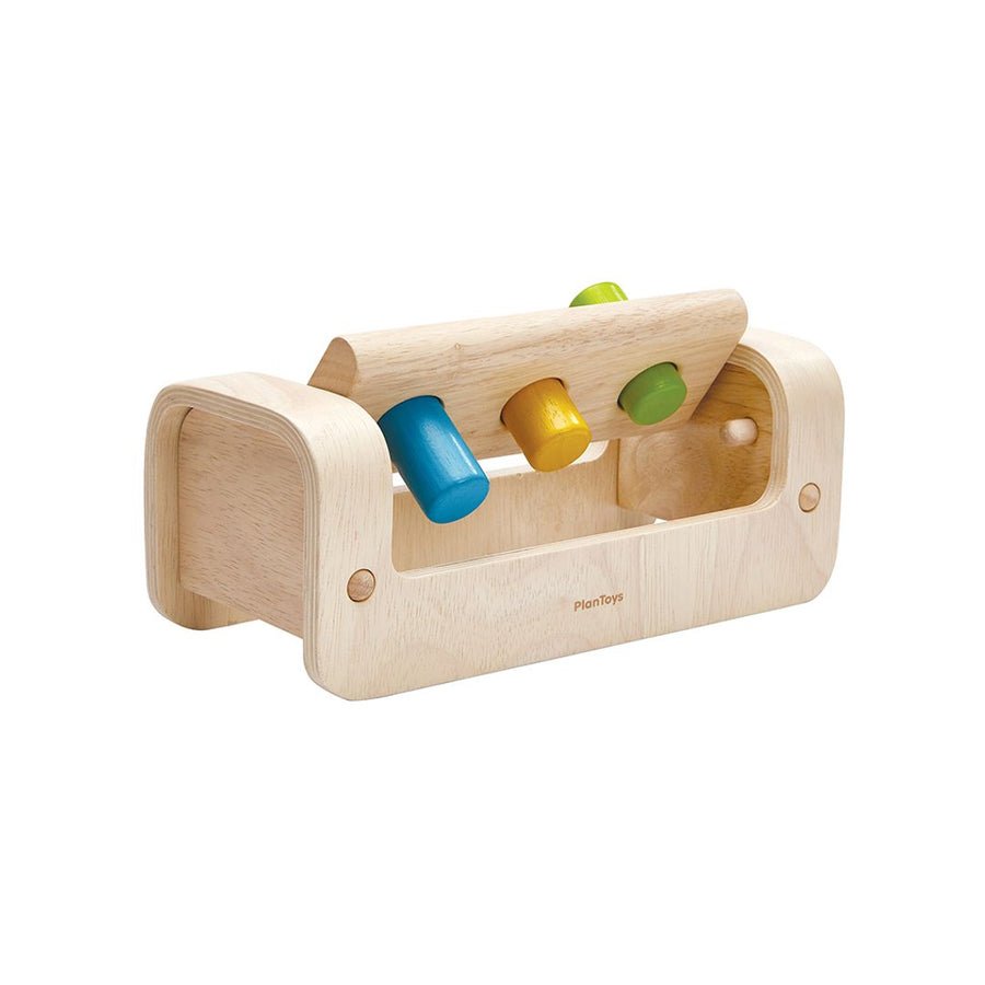 Wooden bench with three pegs and a rotating board on a white background