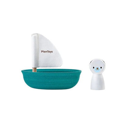 Teal toy boat with white sail and bear figure on a white background, featuring PlanToys branding.