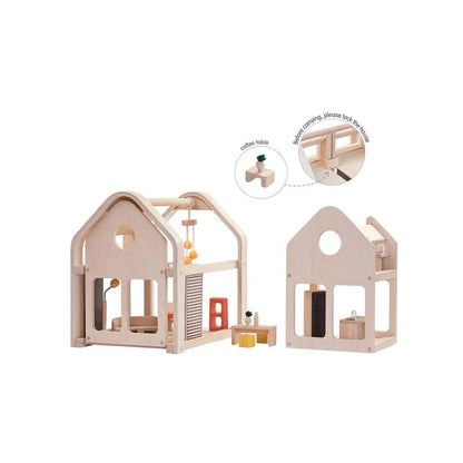 Wooden dollhouse with detailed furniture on a white background