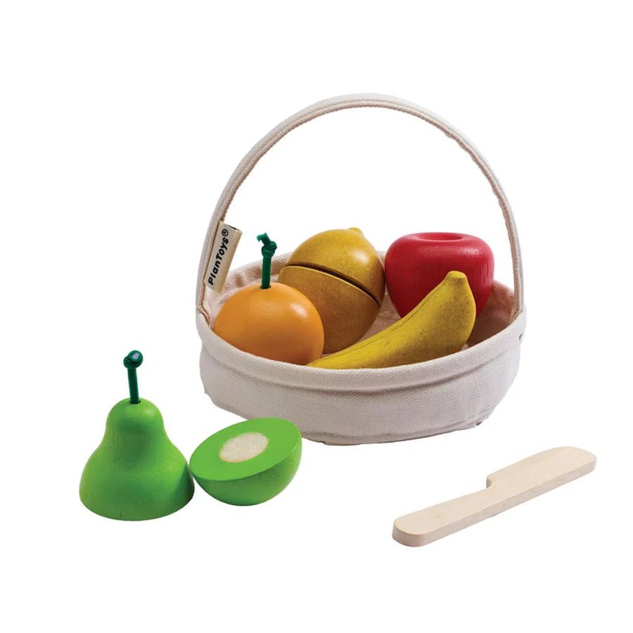 Wooden toy fruit set with fabric basket on a white background