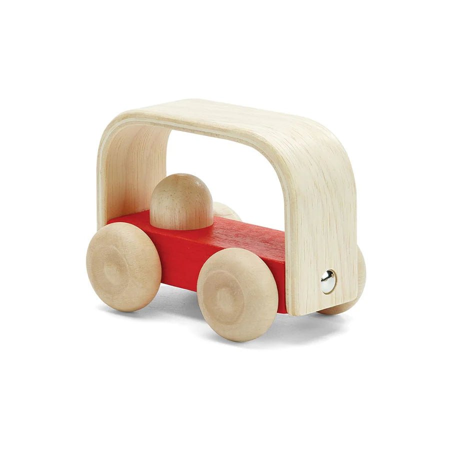 Red wooden toy bus on a white background