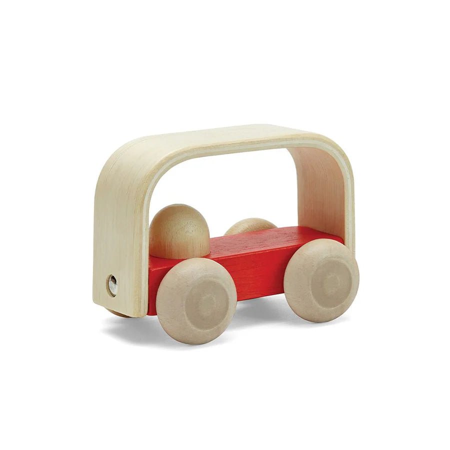 Side angle of red wooden toy bus on a white background