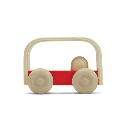 Side view of red toy bus on a white background