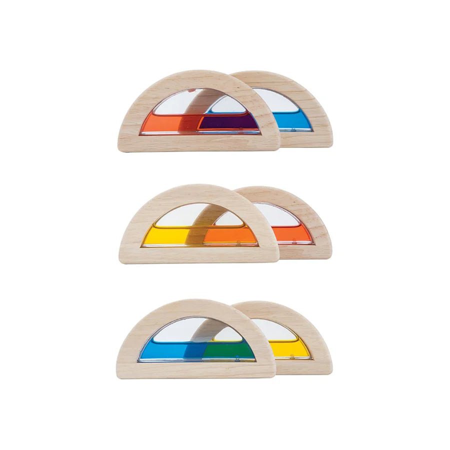 Set of wooden arch-shaped blocks filled with colored water on a white background
