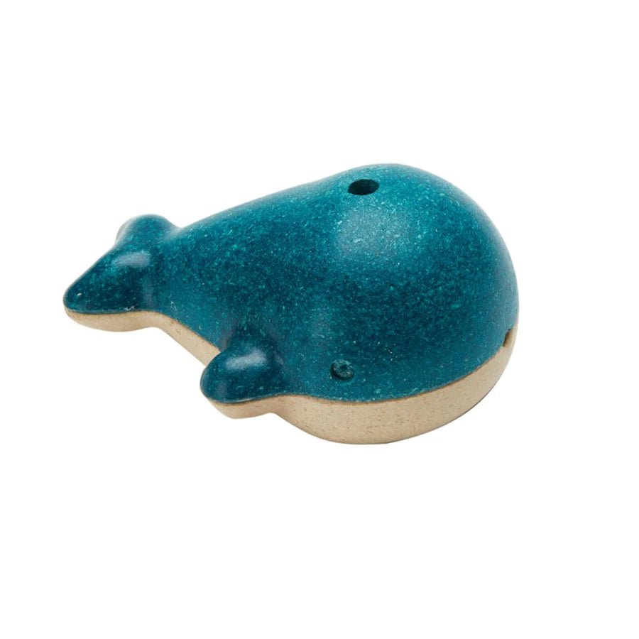 Blue wooden whale-shaped whistle on a white background