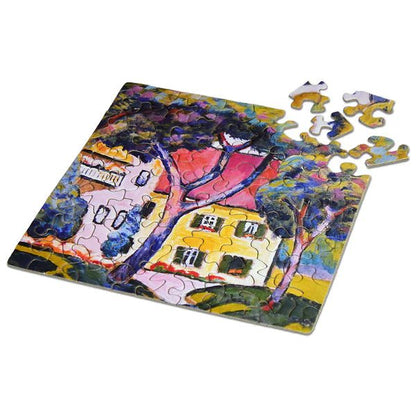 Colorful puzzle with a house and tree design on a white background