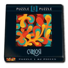Puzzle box with colorful abstract design and 'Curiosi' branding on a white background