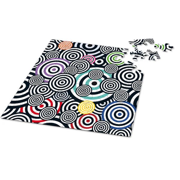 Puzzle with black and white squiggle pattern with pops of color on a white background, with pieces missing