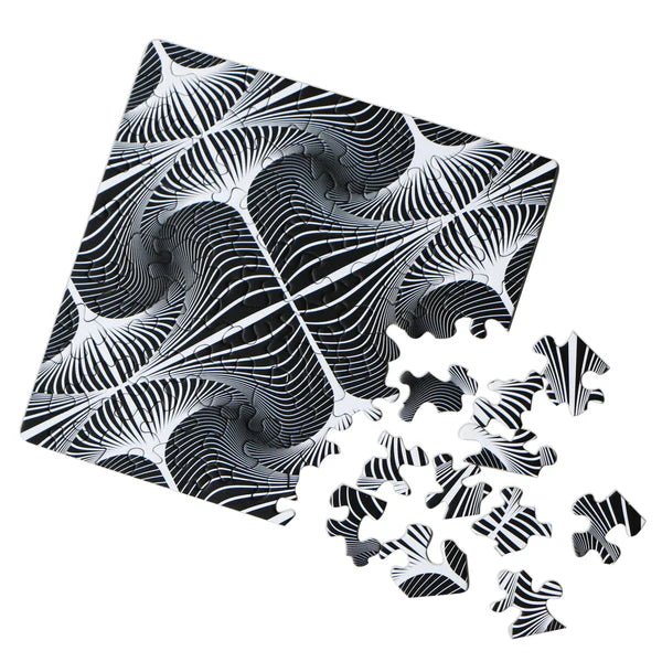 Black and white patterned puzzle with pieces scattered on a white background